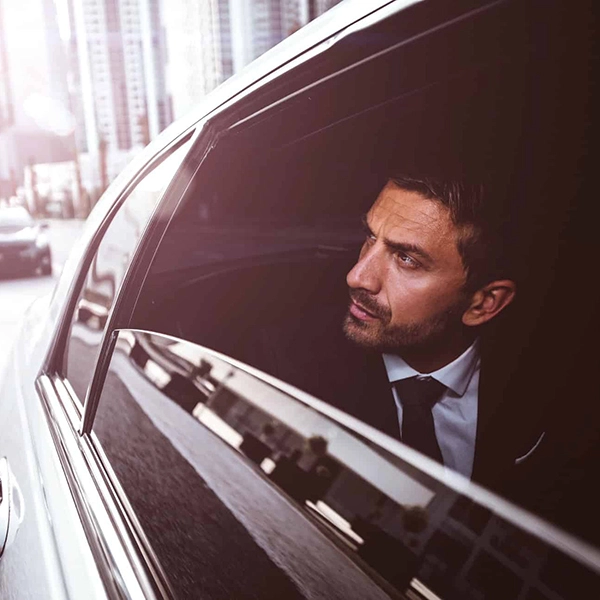 Executive protection professional near luxury vehicle